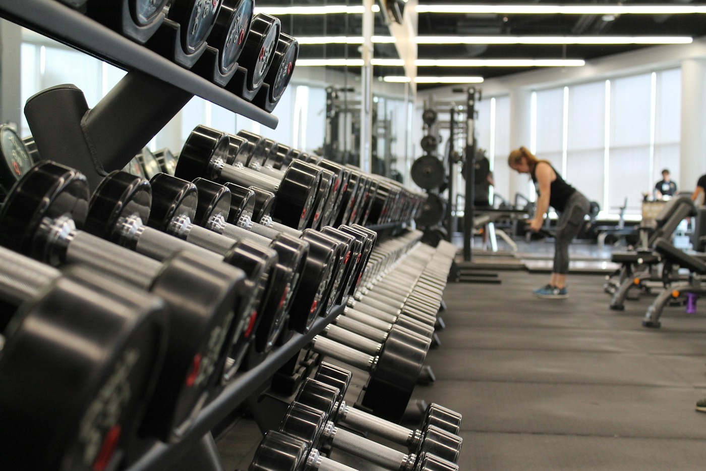 Racks of weights in a bright gym